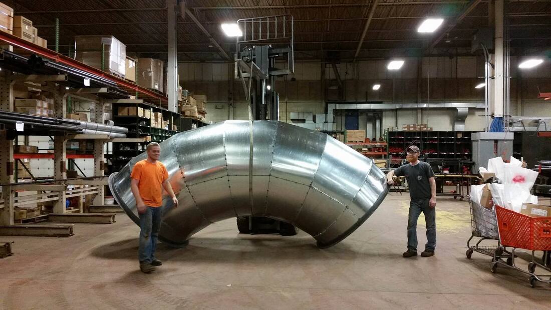 Picture of Local 1 members with fabricated large industrial round ductwork, (Not unauthorized S.M.A.R.T. Local 15's work or members)